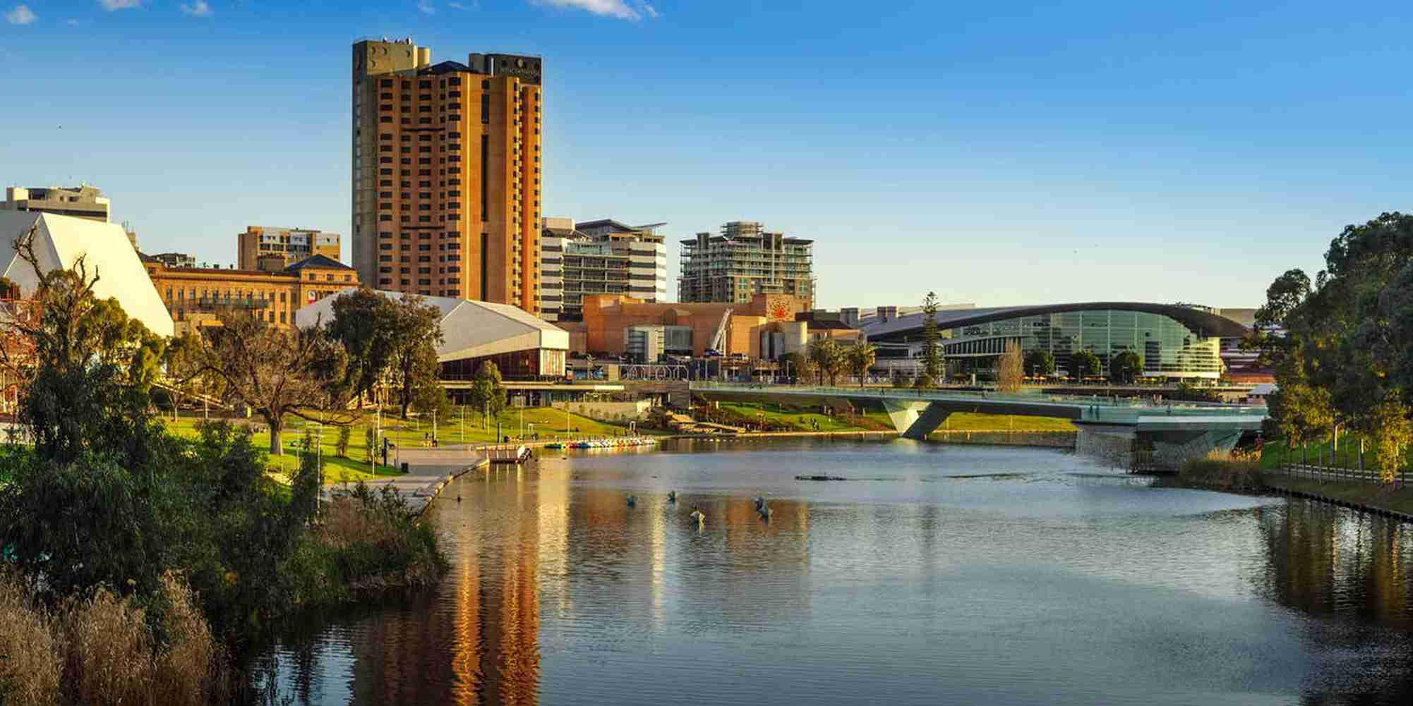 Beautiful view of Adelaide city skyline with river and greenery. | Elite Rail Journey