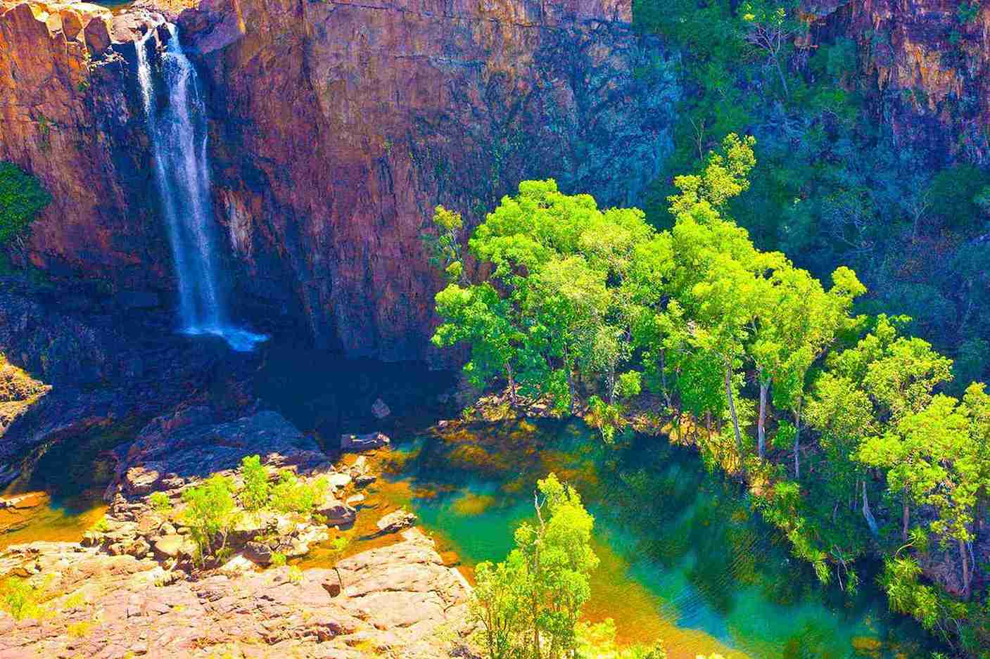 Stunning waterfall and lush greenery at Nitmiluk National Park, Australia. | Elite Rail Journey