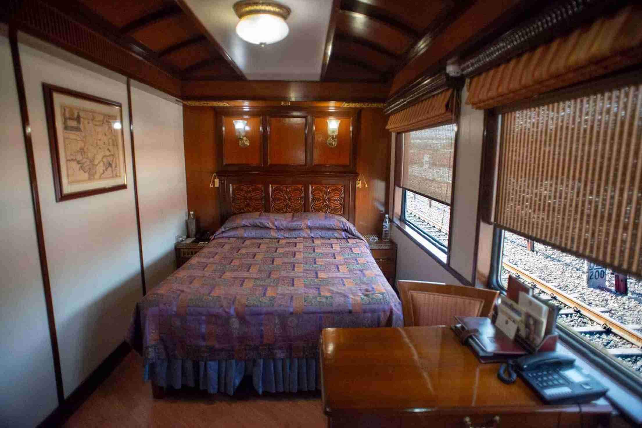 Elegant Gold Service cabin in The Ghan train with a comfortable bed and scenic window view.