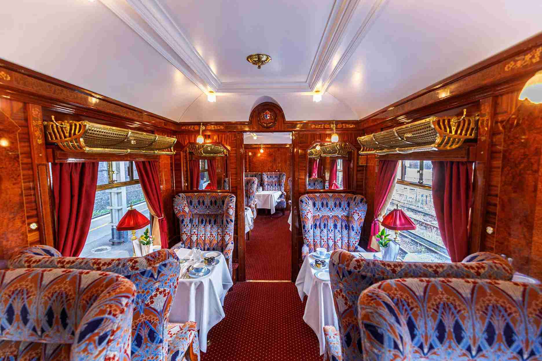 Luxurious train dining area with elegant seating and decor onboard | Elite Rail Journey